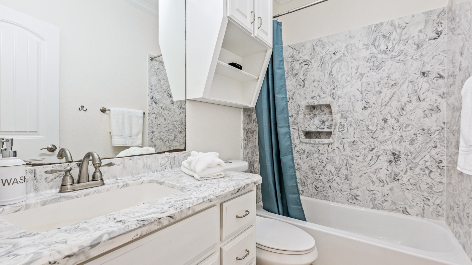 a double bed with a shower and a sink